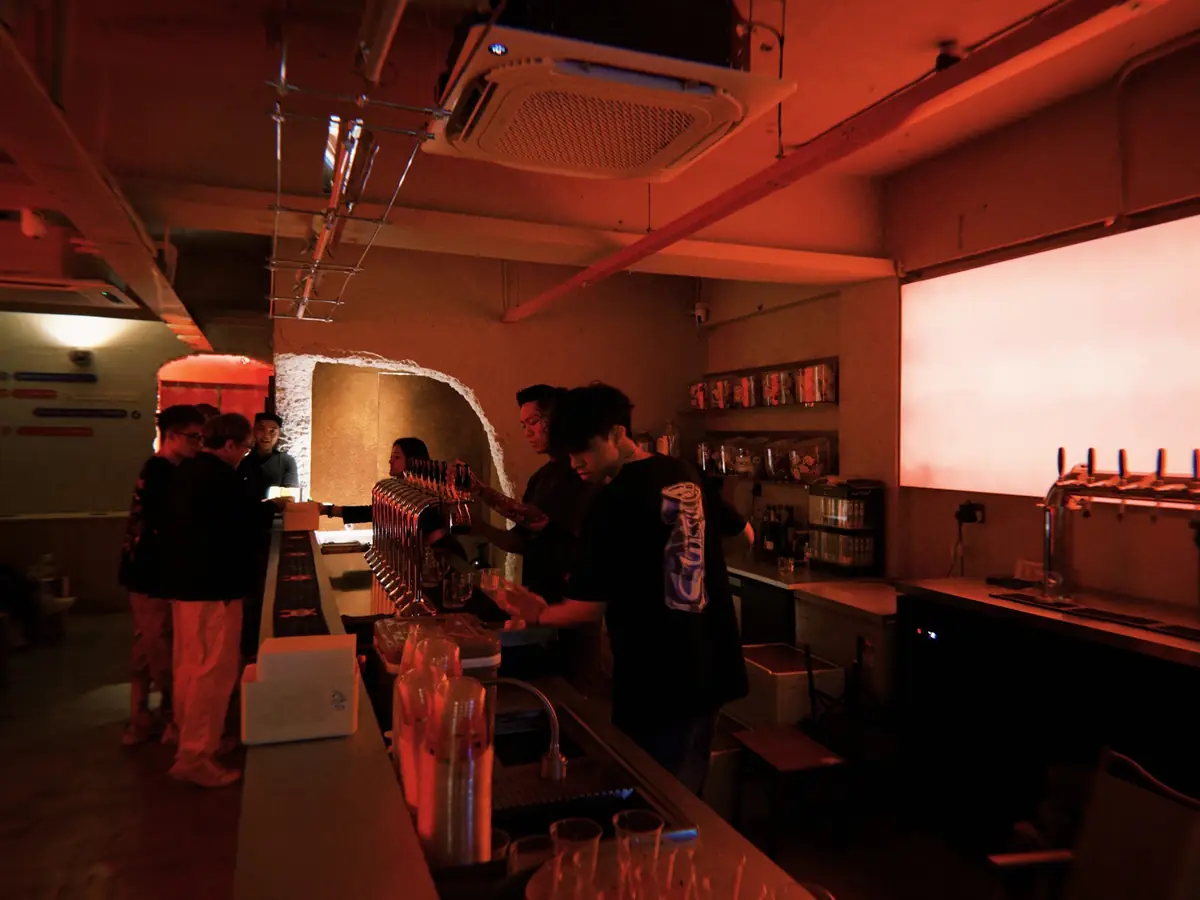 The bar under red light with guests ordering