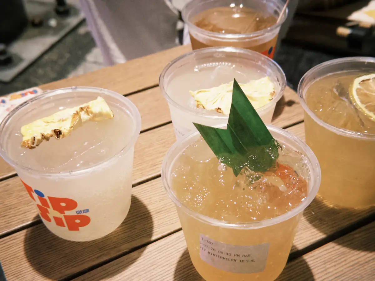 Four TipSip cocktails on a wooden table